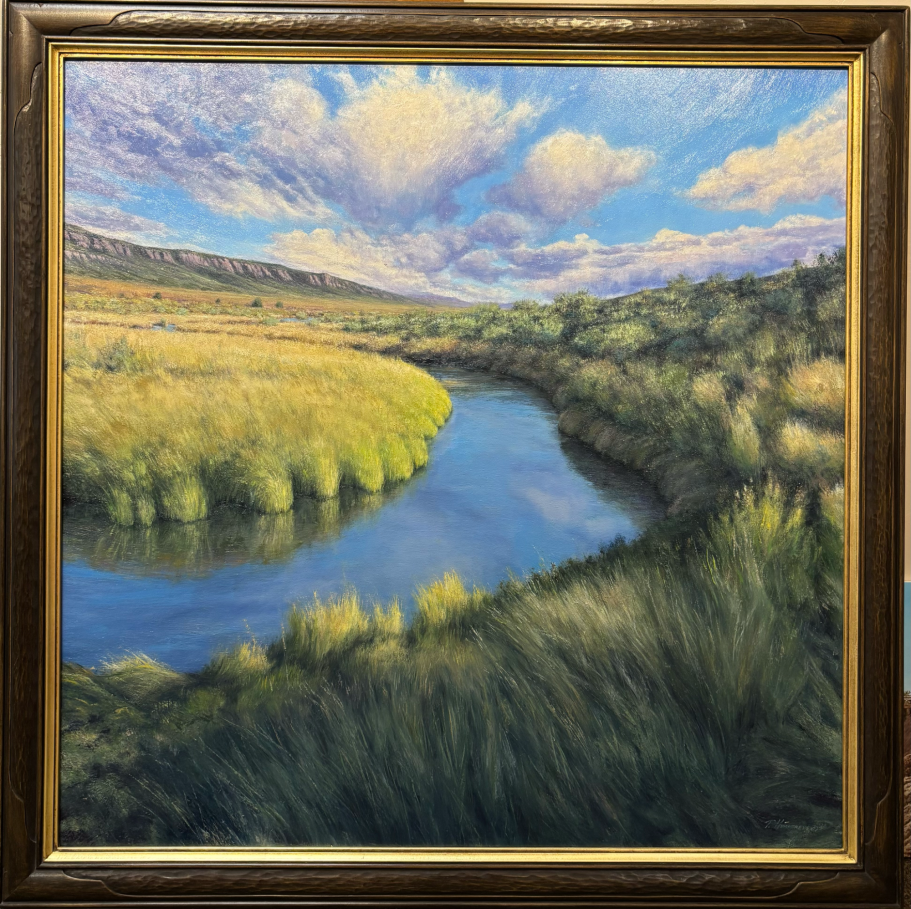 Koosharem Lush landscape with a winding river surrounded by green fields and a blue sky with clouds.