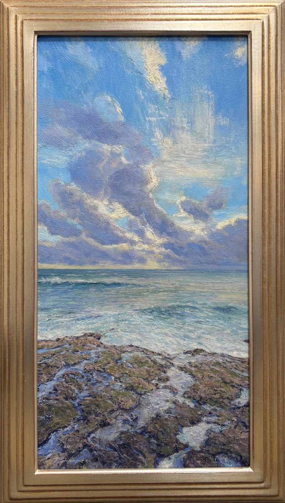 I'd Rather Be in Hawaii Seascape featuring rocky shore, blue sky, and clouds reflecting on the water.