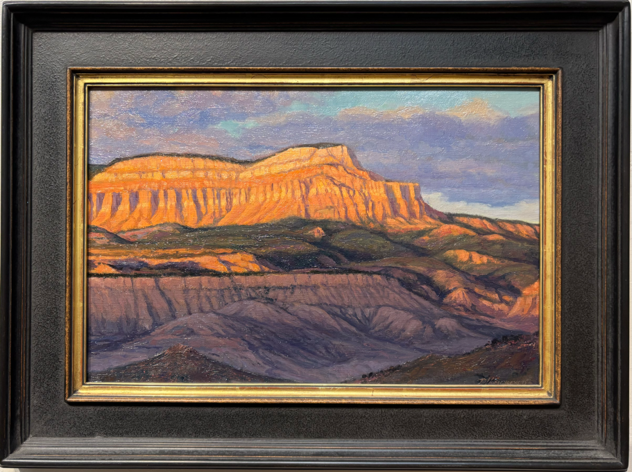 Powell Point Sunlit mountain range with layered rock formations under a cloudy sky. Framed artwork.