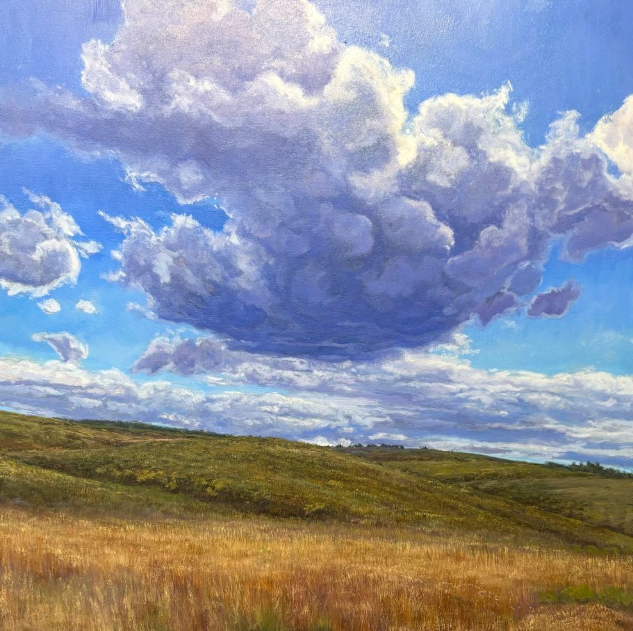 Mountain Clouds Vast landscape with rolling hills and dramatic clouds against a bright blue sky.